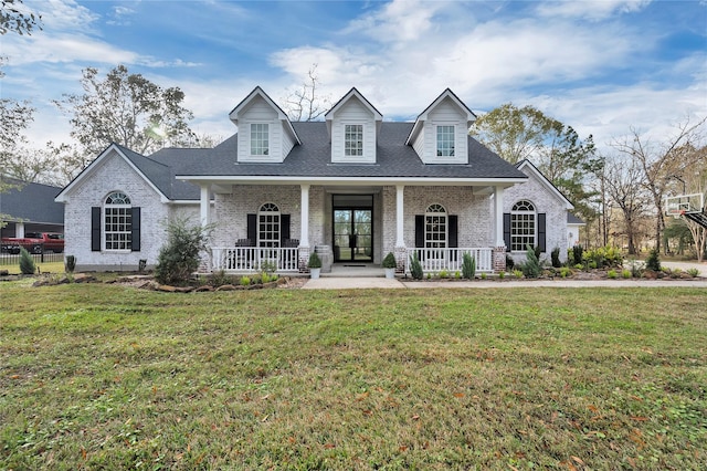 cape cod-style house featuring a front lawn and a porch