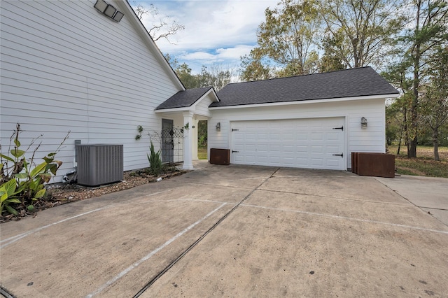 view of front facade featuring central AC and a garage