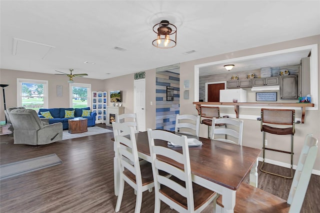 dining area featuring ceiling fan and dark wood-type flooring