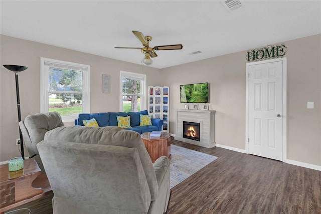 living room with ceiling fan and dark hardwood / wood-style floors