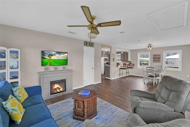 living room featuring ceiling fan and hardwood / wood-style floors