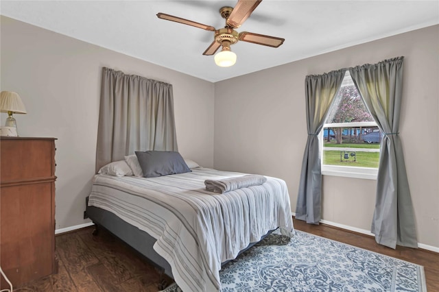 bedroom with dark wood-type flooring and ceiling fan