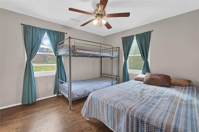 bedroom with ceiling fan and dark hardwood / wood-style flooring