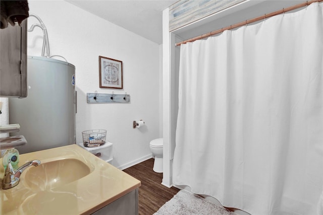 bathroom with vanity, toilet, and hardwood / wood-style flooring