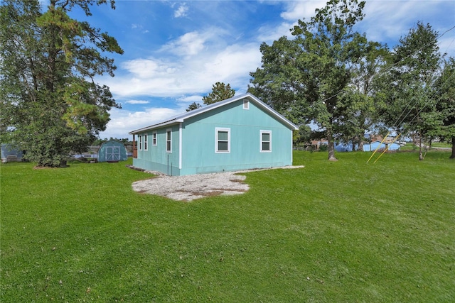 view of property exterior featuring a lawn and a shed