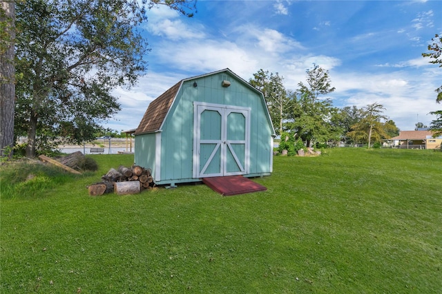 view of outbuilding featuring a lawn