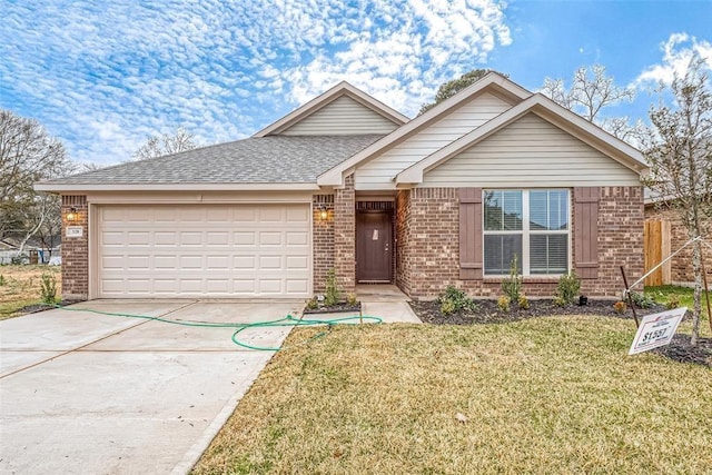 view of front of home with a garage and a front yard