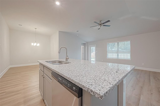 kitchen with pendant lighting, dishwasher, a kitchen island with sink, ceiling fan with notable chandelier, and sink