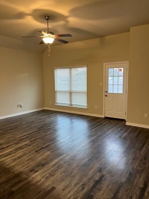 unfurnished living room with lofted ceiling, baseboards, dark wood finished floors, and a ceiling fan