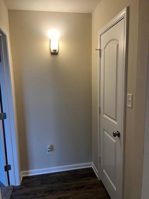 interior space with dark wood-style floors and baseboards