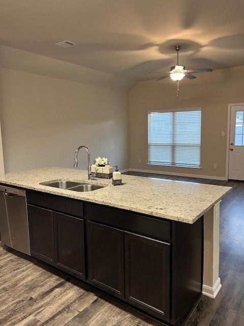 kitchen featuring dark wood finished floors, open floor plan, a sink, and dishwasher