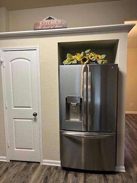 kitchen featuring dark wood-style floors, baseboards, and stainless steel fridge with ice dispenser