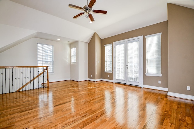 interior space featuring french doors, light hardwood / wood-style floors, ceiling fan, and lofted ceiling