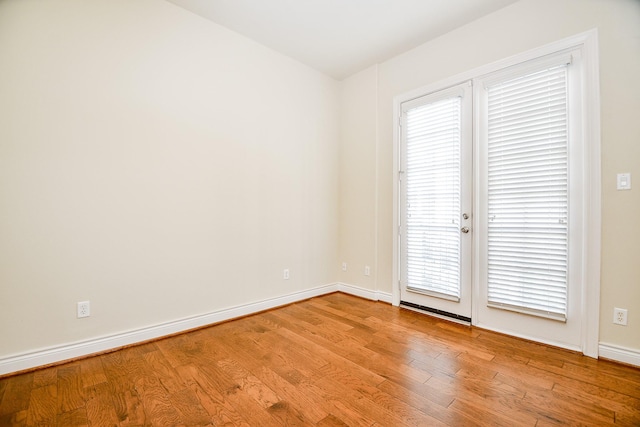 spare room featuring light hardwood / wood-style floors