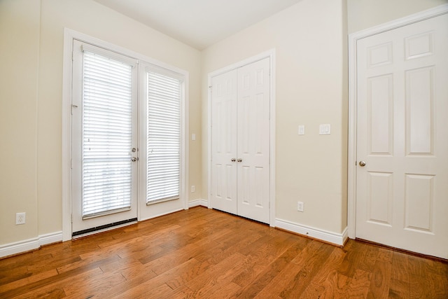 unfurnished bedroom featuring light hardwood / wood-style floors and multiple windows