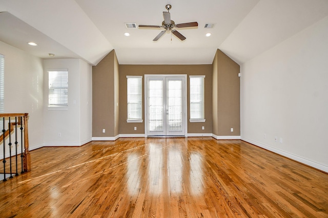 interior space featuring ceiling fan, french doors, lofted ceiling, and light wood-type flooring