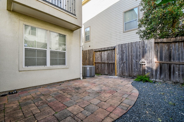 view of patio with central AC and a balcony