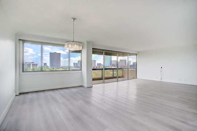 interior space with a chandelier and light hardwood / wood-style floors