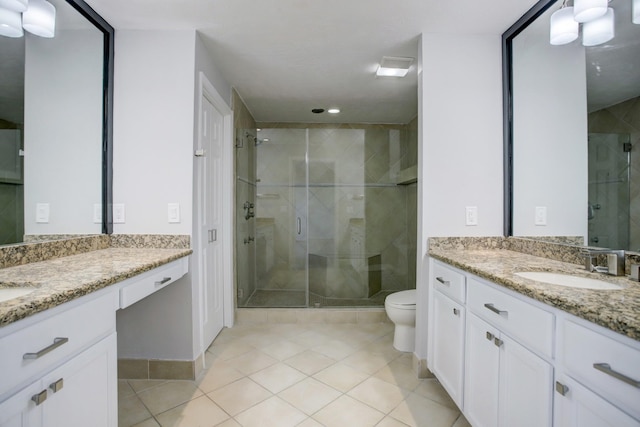 bathroom featuring tile patterned floors, vanity, toilet, and walk in shower