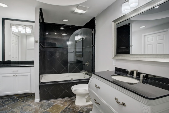 full bathroom with vanity, toilet, and tiled shower / bath