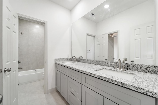 full bathroom featuring tile patterned floors, toilet, vanity, and tiled shower / bath