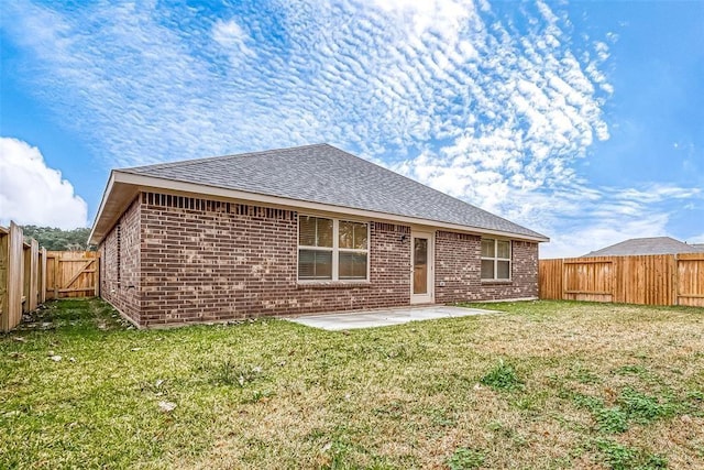 back of property featuring a lawn and a patio area