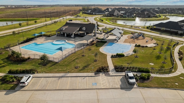 birds eye view of property with a water view