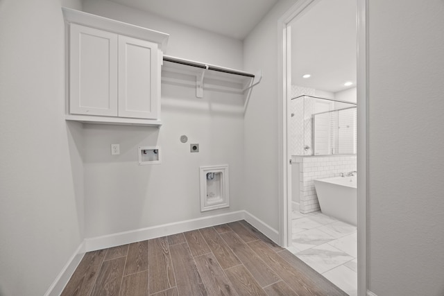 laundry area with electric dryer hookup, cabinets, and hookup for a washing machine