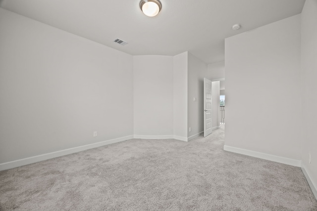 unfurnished room with light colored carpet