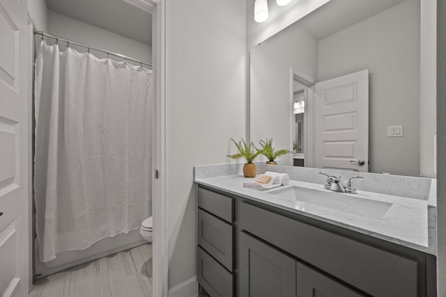 full bathroom with shower / tub combo, vanity, and toilet