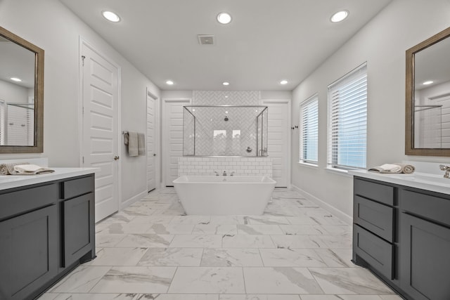 bathroom with vanity and independent shower and bath