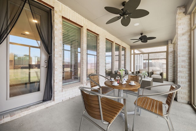 sunroom / solarium featuring ceiling fan and plenty of natural light