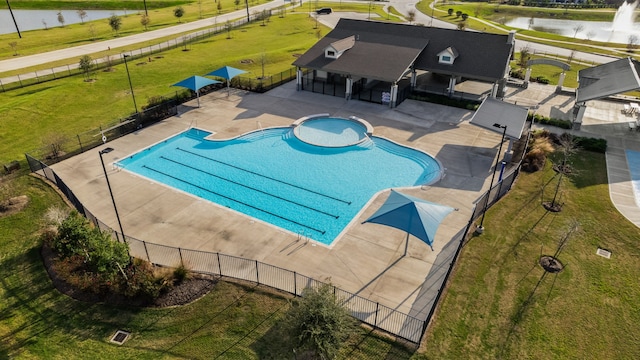 view of pool featuring a water view and a patio area