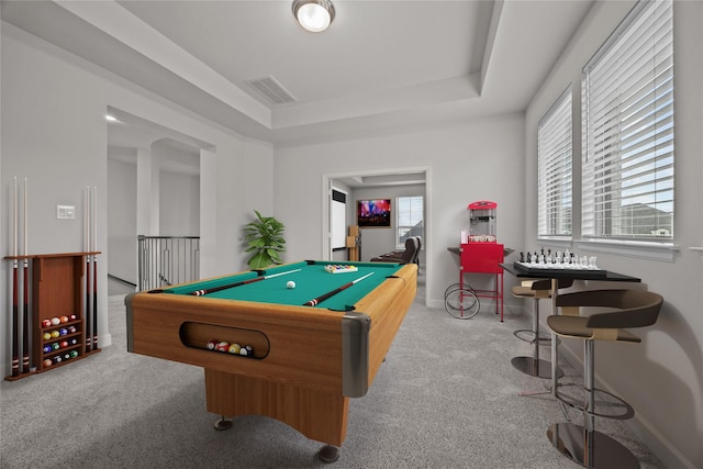 recreation room with pool table, light colored carpet, a wealth of natural light, and a tray ceiling