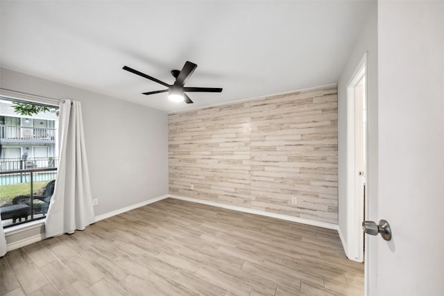 empty room featuring ceiling fan and light hardwood / wood-style flooring