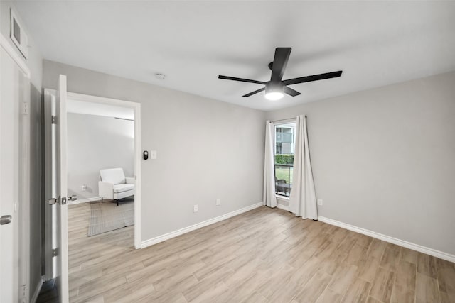 empty room featuring light hardwood / wood-style flooring and ceiling fan