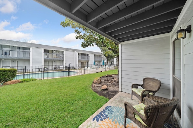 view of yard with a fenced in pool and a patio area