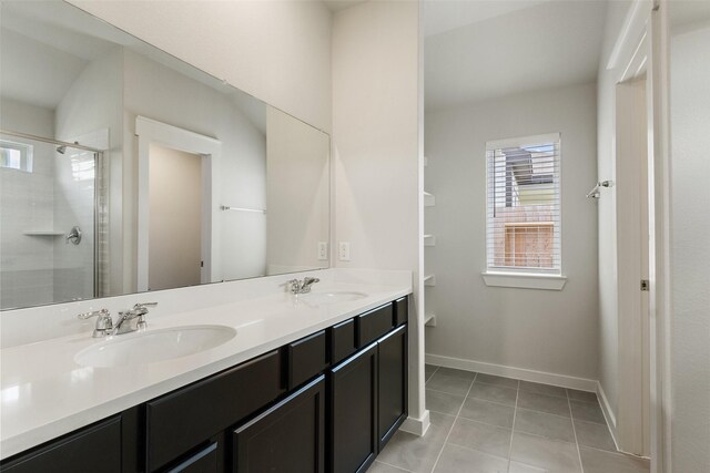 2971 Colonia Blossom Ln, Pinehurst, TX 77362 - full bathroom with plenty of natural light, a tile shower, double vanity, and baseboards