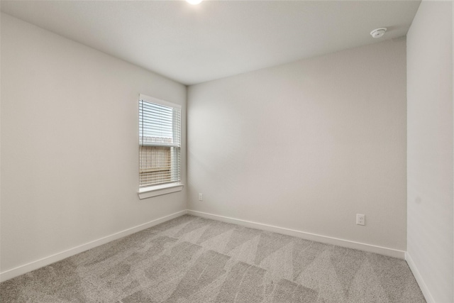 2971 Colonia Blossom Ln, Pinehurst, TX 77362 - empty room featuring light carpet, baseboards, and a smoke detector