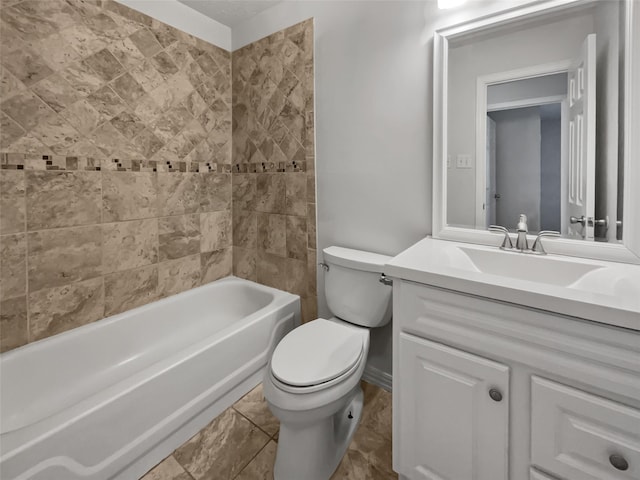 full bathroom with toilet, tiled shower / bath, and vanity