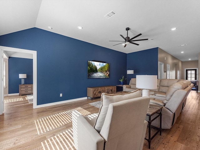 living room with vaulted ceiling, light hardwood / wood-style flooring, and ceiling fan