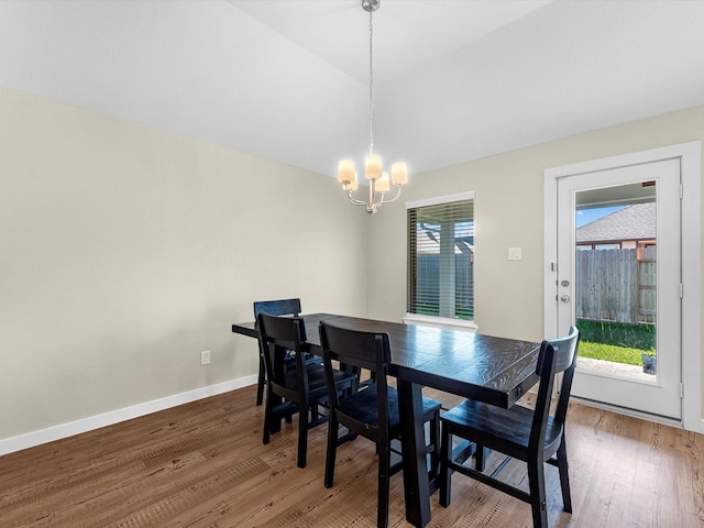 dining area featuring hardwood / wood-style floors and a notable chandelier