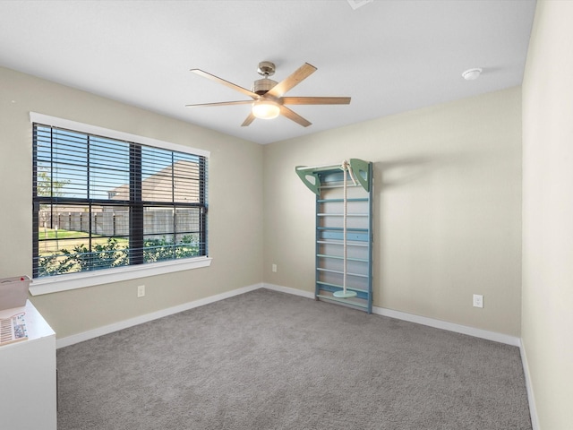 carpeted empty room featuring ceiling fan