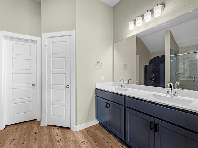 bathroom featuring vanity, an enclosed shower, and hardwood / wood-style flooring