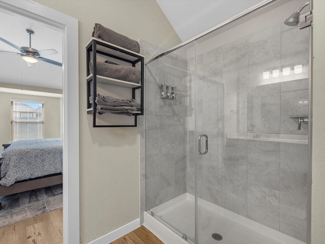 bathroom featuring ceiling fan, wood-type flooring, lofted ceiling, and walk in shower