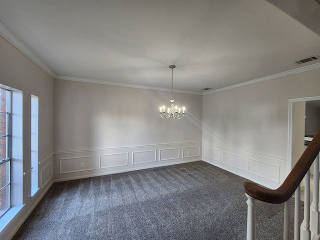 carpeted empty room with a chandelier and crown molding