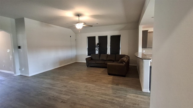 living room with dark hardwood / wood-style floors, ceiling fan, and lofted ceiling