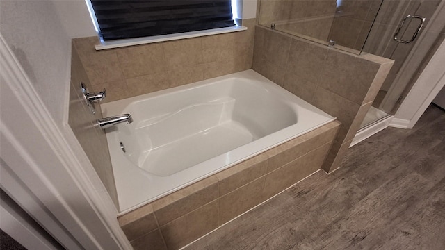 bathroom with plus walk in shower and wood-type flooring