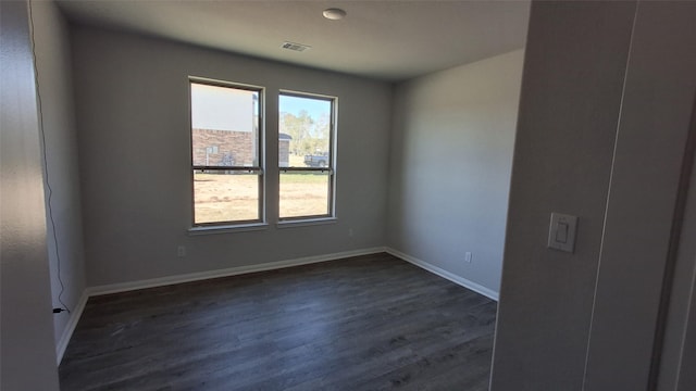 spare room featuring dark wood-type flooring