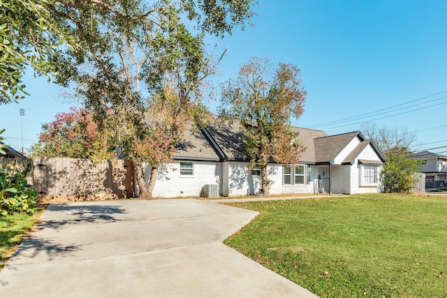 view of front of house featuring a front yard and central AC